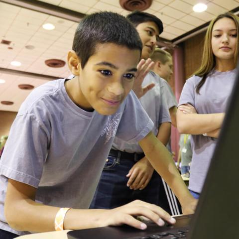 young boy programming on the computer