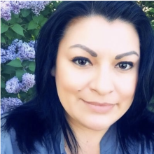 headshot of woman in front of flowers